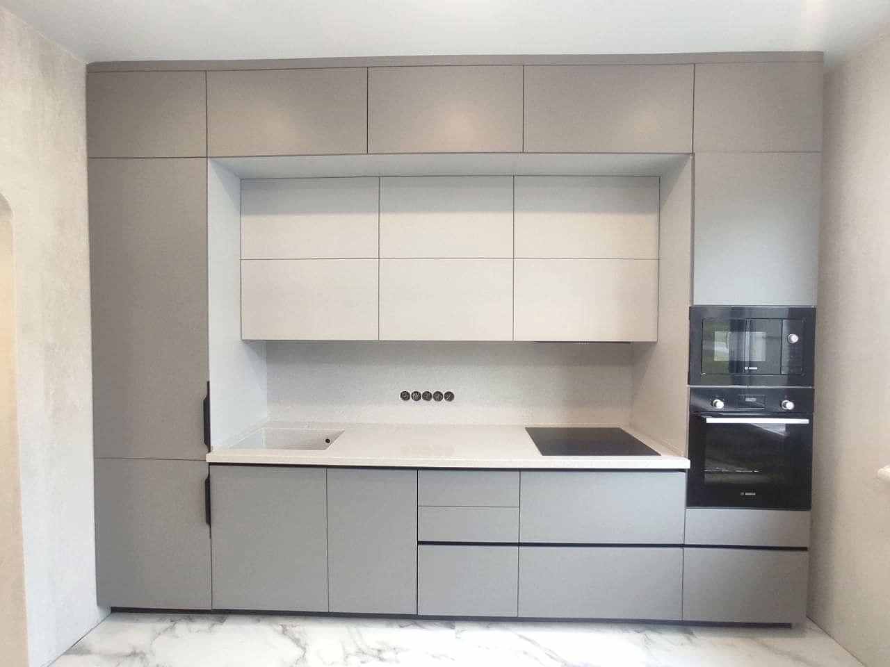 Встроенная нюдово-серая кухня с пеналами по бокам - фото - 1